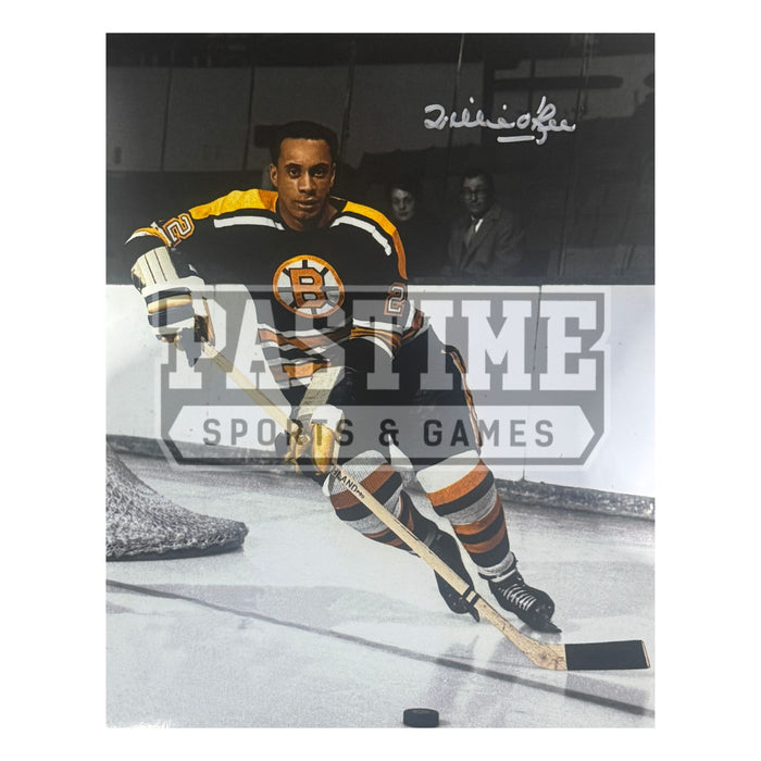 Willie O'Ree Autographed Boston Bruins Photo (Behind Net With Puck) - Pastime Sports & Games