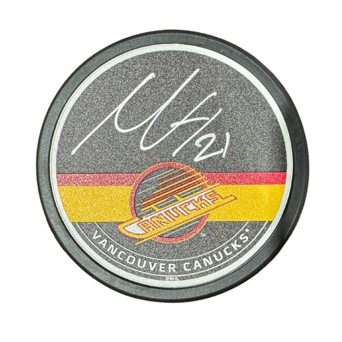 Nils Höglander Autographed Vancouver Canucks Skate Hockey Puck (Textured Mustang Autograph Puck)