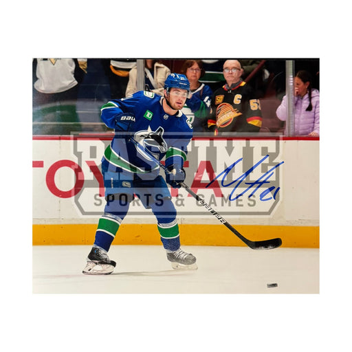 Nils Hoglander Autographed Vancouver Canucks Photo (Passing The Puck) - Pastime Sports & Games