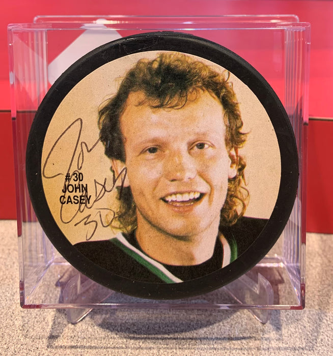 Jon Casey Autographed Minnesota North Stars Hockey Puck - Pastime Sports & Games