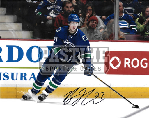 Ben Hutton Autographed 8X10 Vancouver Canucks Home Orca Jersey (Skating With Puck) - Pastime Sports & Games