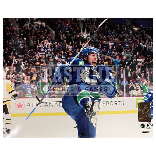 Kevin Bieksa 8X10 Canucks Home Jersey (Skating With Puck Crowd in Back)