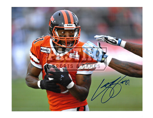 Geroy Simon Autographed 8X10 B.C Lions Home Jersey (Protecting Ball) - Pastime Sports & Games